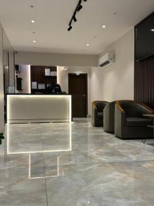 a lobby with couches and a table in a building at الشمائل الراقيه للشقق المخدومة in Taif +1 photo