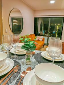 a table with plates and wine glasses on it at Confort & luxury Apt- San Isidro in Lima