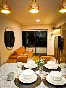 a living room with a table with plates and wine glasses at Confort & luxury Apt- San Isidro in Lima