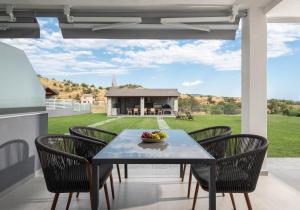 a table and chairs on a patio with a view at Bianca's House in Nikiti