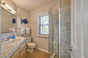a bathroom with a shower and a toilet and a sink at Beachfront Sunset in Encinitas +38 photos