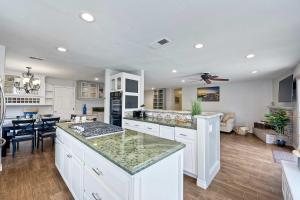 a kitchen with white cabinets and a living room at Carlsbad Charm - 3BR Stunner in Carlsbad