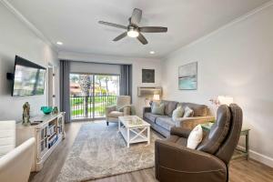 a living room with a couch and a ceiling fan at La Costa Gem - Condo for 3 in Carlsbad