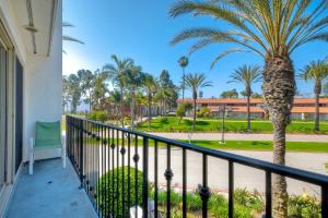 a balcony with palm trees and a building at La Costa Gem - Condo for 3 in Carlsbad