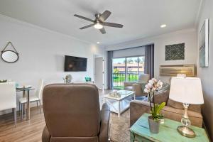 a living room with a couch and a ceiling fan at La Costa Gem - Condo for 3 in Carlsbad