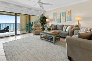 a living room with a couch and a table at Spacious Beachfront Retreat - Sauna Pools & More in Perdido Key