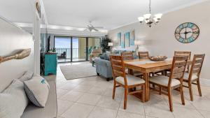 a dining room and living room with a table and chairs at Spacious Beachfront Retreat - Sauna Pools & More in Perdido Key