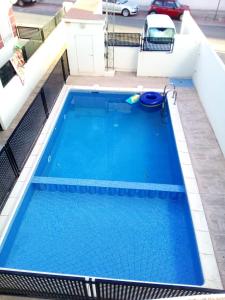 a swimming pool on the roof of a building at Piso Playa de Canet in Canet de Berenguer