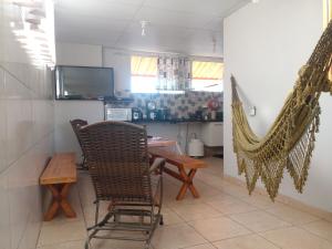 a living room with a table and a hammock at Hostel Gerais in Belo Horizonte