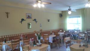 a dining room filled with tables and chairs with bats on the wall at Hotel Magda in Rimini