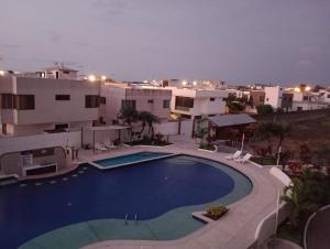 a large swimming pool in front of a building at Playa Costa Azul Tonsupa- Esmeraldas in Volcán Chimborazo