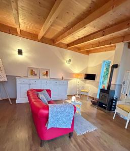 Una sala de estar con un sofá rojo y una chimenea. en Cottage Gols, en Gols