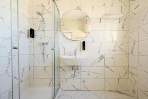 a bathroom with a sink and a glass shower at F8-4 Sliema ensuite bedroom in Sliema