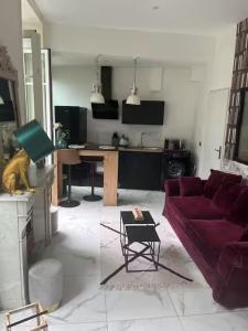 a living room with a couch and a table at Studio Cosy - Cœur de Saint-Vallier in Saint-Vallier