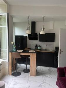 a kitchen with a wooden table in a room at Studio Cosy - Cœur de Saint-Vallier in Saint-Vallier