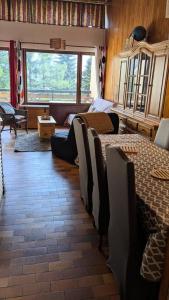 a living room with two tables and a couch at Résidence Horizon E - deux pièces 5 pers plein SUD Horizon 1800 MAE-6211 in Orcières