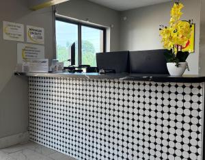 a restaurant counter with a white and black checkered counter at Super 8 by Wyndham Evansville East in Evansville