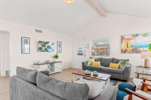 a living room with two couches and a table at Tranquil Turquoise - Pet Friendly in Port Aransas