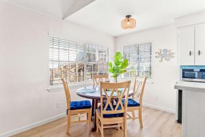 a kitchen and dining room with a table and chairs at Tranquil Turquoise - Pet Friendly in Port Aransas +20 photos