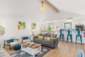 a living room with a couch and a table at Tranquil Turquoise - Pet Friendly in Port Aransas
