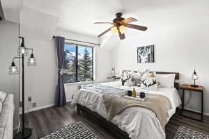 a bedroom with a bed with a ceiling fan at Cozy PC Condo - Top Floor Studio in Park City