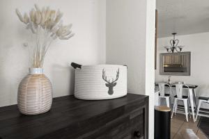 a vase sitting on top of a wooden counter with a vase at Cozy PC Condo - Top Floor Studio in Park City