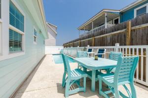 a blue table and chairs on a patio at Cozy 2 Bedroom Monthly Rates Pets & Pool in Port Aransas