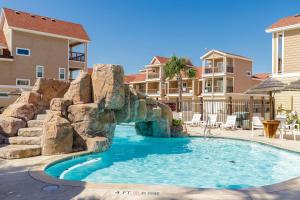 a pool with a water slide in a resort at Fun 4 Bedroom - Resort Pool Sleeps 12 in Port Aransas