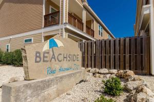 a sign in front of a building with a beachside apartment at Fun 4 Bedroom - Resort Pool Sleeps 12 in Port Aransas +33 photos