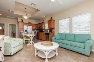 a living room with a couch and a table at Fun 2 bedroom - Pets Pool Sleeps 6 in Port Aransas