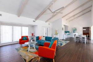 a living room with a blue couch and red chairs at Stylish 3 bedroom - Pool Pets Sleeps 10 in Port Aransas +38 photos