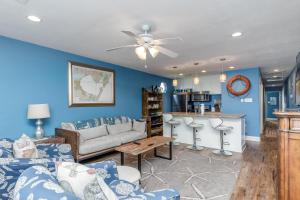 a living room with a couch and a table at The Oasis - Pet Friendly Optional Golf Cart in Port Aransas