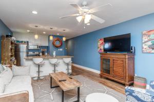 a living room with a couch and a flat screen tv at The Oasis - Pet Friendly Optional Golf Cart in Port Aransas +35 photos
