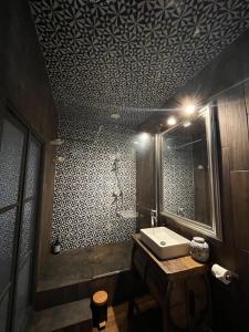 a bathroom with a sink and a mirror at Villa mon repos Annebecq in Landelles-et-Coupigny