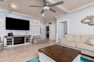 a living room with a flat screen tv and a couch at Modern Comfort 3 Bedroom Pets in Port Aransas