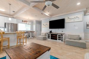 a living room with a flat screen tv on the wall at Modern Comfort 3 Bedroom Pets in Port Aransas +40 photos