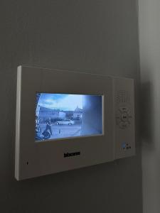 a television on a wall with a picture on it at MA Housing - Central Apartment in Cluj-Napoca +4 photos