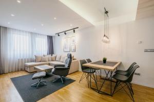 a living room with a couch and a table at Ilidža Luxe Apartment in Sarajevo
