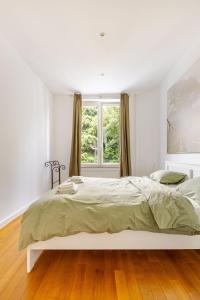 En eller flere senge i et værelse på Maison du Cinquantenaire - The Residential