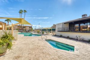 a patio with two swimming pools and a building at 2BR Sleeps 6 Pool BBQ Gym Hot Tub & Bar Hopping in Scottsdale