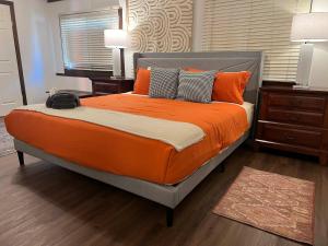 a bedroom with a bed with an orange comforter at Oak Creek Viewpoint The Views in Sedona