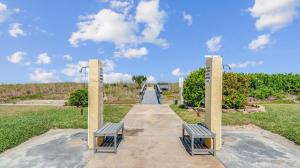 two benches on a walkway in a park at Flip Flop Foray at Cocoa Beach in Cocoa Beach
