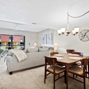a living room with a couch and a table at 2BR Sleeps 6 Pool BBQ Steps to Beach Pier Downtown in Cocoa Beach