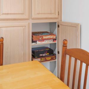 a dining room table with a stack of books at Beachfront 2BR Condo with Pool BBQ & Steps To Beach in Cocoa Beach