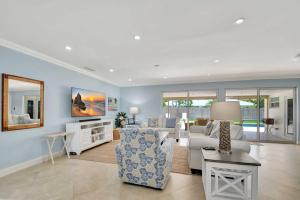 a living room with a couch and a table at Dolphin Villa - Private Pool in West Palm Beach