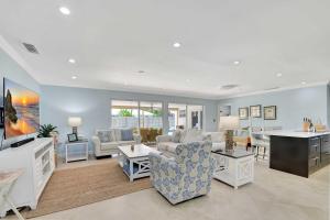a living room with couches and a dining room at Dolphin Villa - Private Pool in West Palm Beach