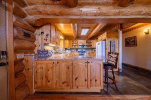 a kitchen with wooden cabinets and a large island at Maggies Cabin - Enjoy a Slice of Paradise in Rexford Montana in Rexford