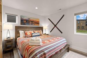a bedroom with a large bed with a large clock on the wall at Whitefish All Seasons Getaway in Whitefish