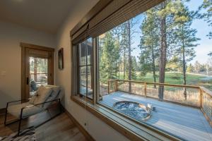a room with a large window with a view of a deck at Wilderness Club Cabin - Sleeps 7 in Eureka