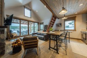 a kitchen and living room with a table and chairs at Wilderness Club Cottage on 18th Green in Eureka